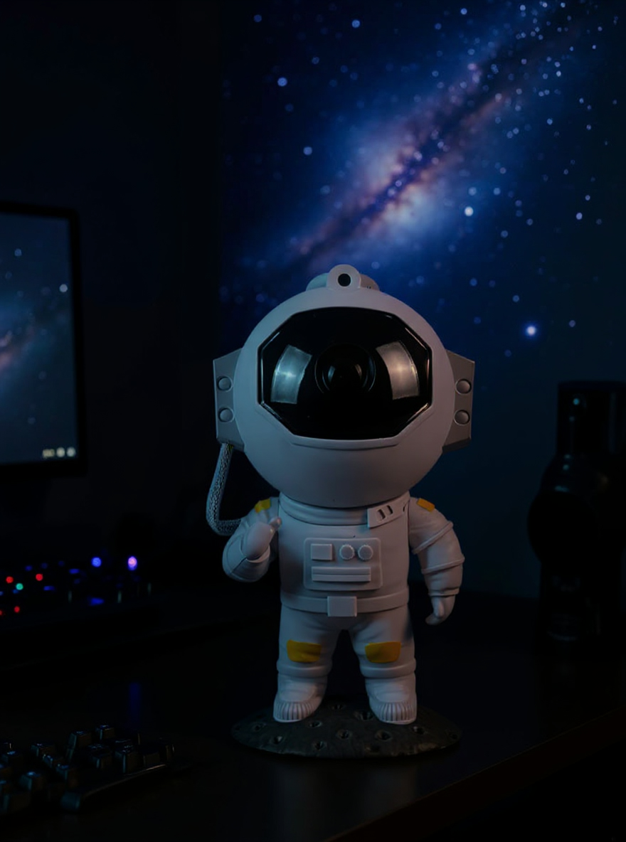 Auroom astronaut projector lighting a gaming desk with a nebula